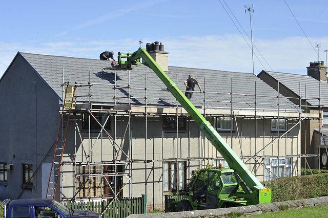 Montgomery County Homeowners: Safely Remove Roof Stains Now Roofers using a telehandler and scaffolding for roof repair on a residential building.
